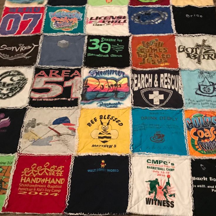 many different t - shirts are arranged on a tablecloth that has been made into a quilt