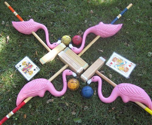 pink flamingos are arranged in the shape of a star with cards and marbles