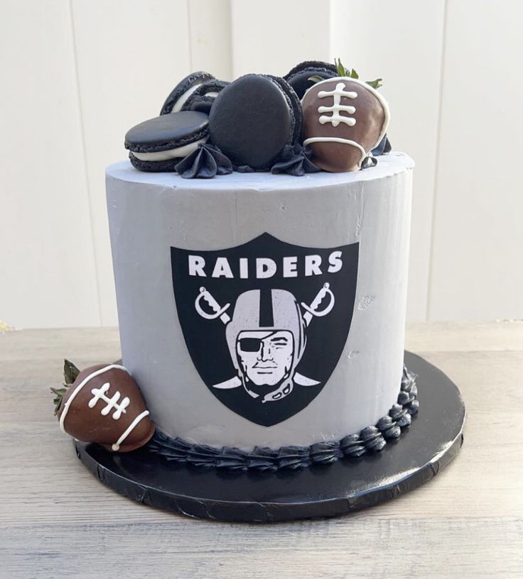 a cake decorated to look like a football helmet and some cookies on the top of it