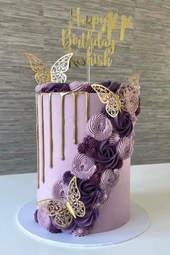 a purple and gold birthday cake with butterflies on top