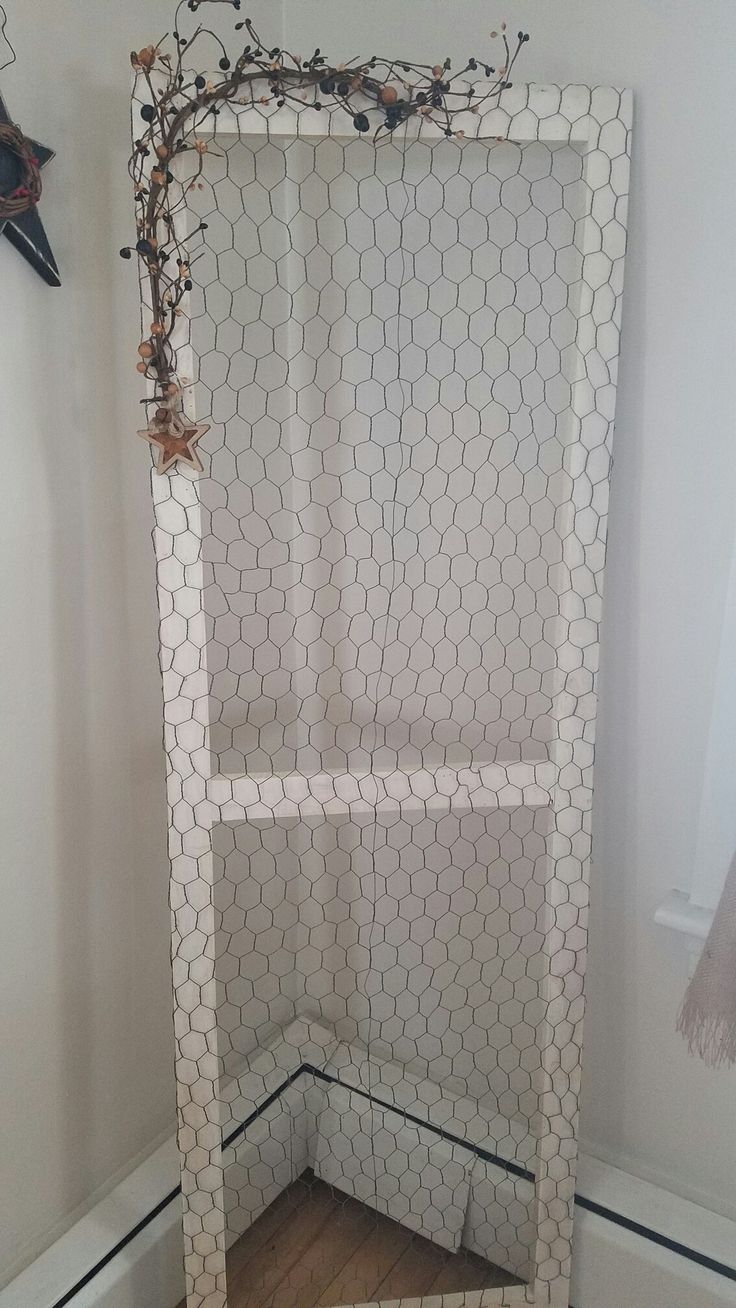 a room with a chicken wire door in the corner