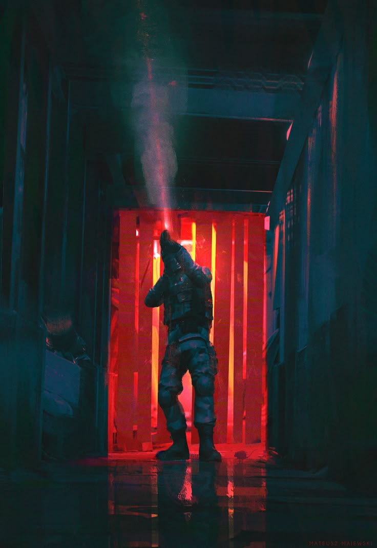 a man standing in the middle of a hallway with red light coming from behind him