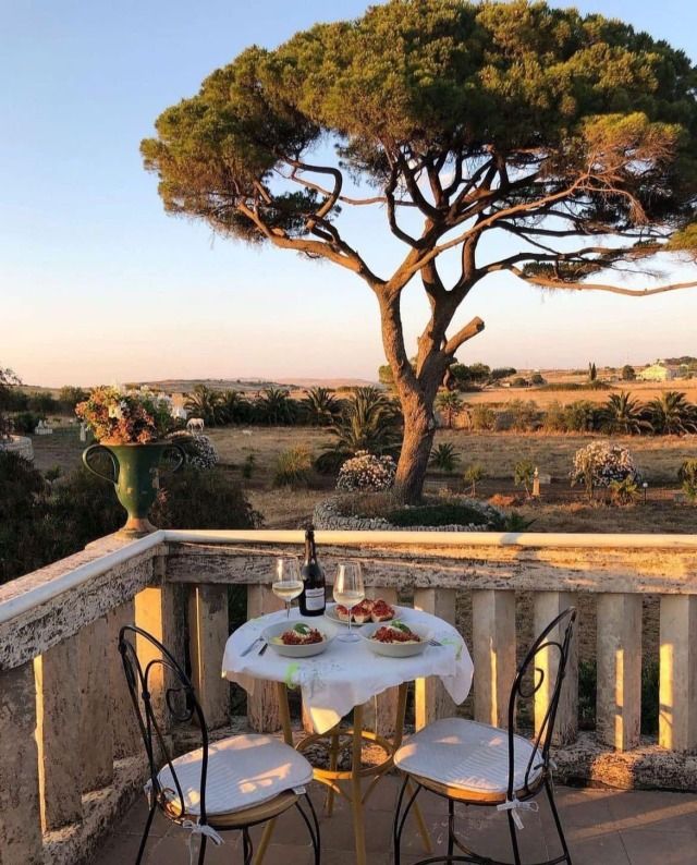 an instagram photo with a table and chairs on the balcony next to a tree