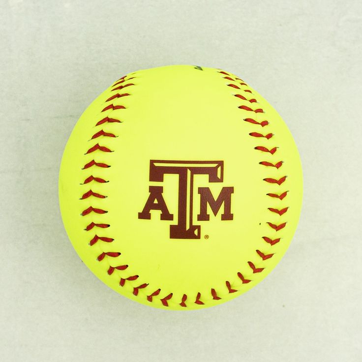 a close up of a yellow baseball with the letters t and m on it's side