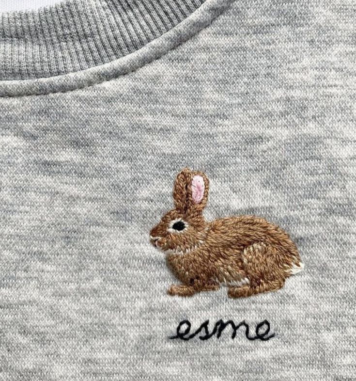 a small rabbit embroidered on the back of a t - shirt