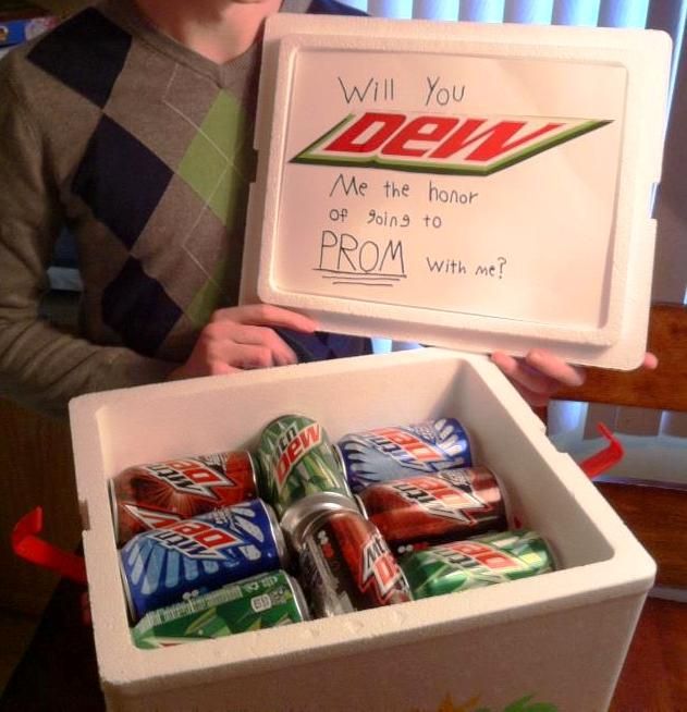 a young boy holding up a box of sodas and a sign that says, will you do me the hour or sing to prom with me?