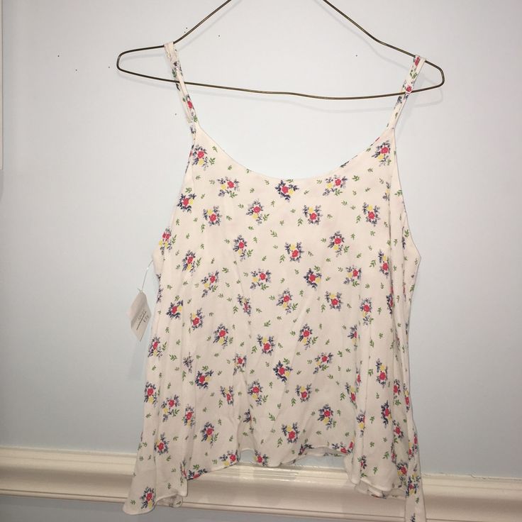 Nwt Floral Flowy Tank In Perfect Condition With Adjustable Straps And Button On Back. Purchased At A Local Boho Boutique Spring Floral Print Cami Blouse, White Printed Sleeveless Blouse, Casual Cami Blouse For Daywear, White Rayon Tops For Spring, White Rayon Tops For Daywear, White Printed Rayon Tops, White Summer Rayon Tops, White Rayon Summer Tops, Women Floral Blouse