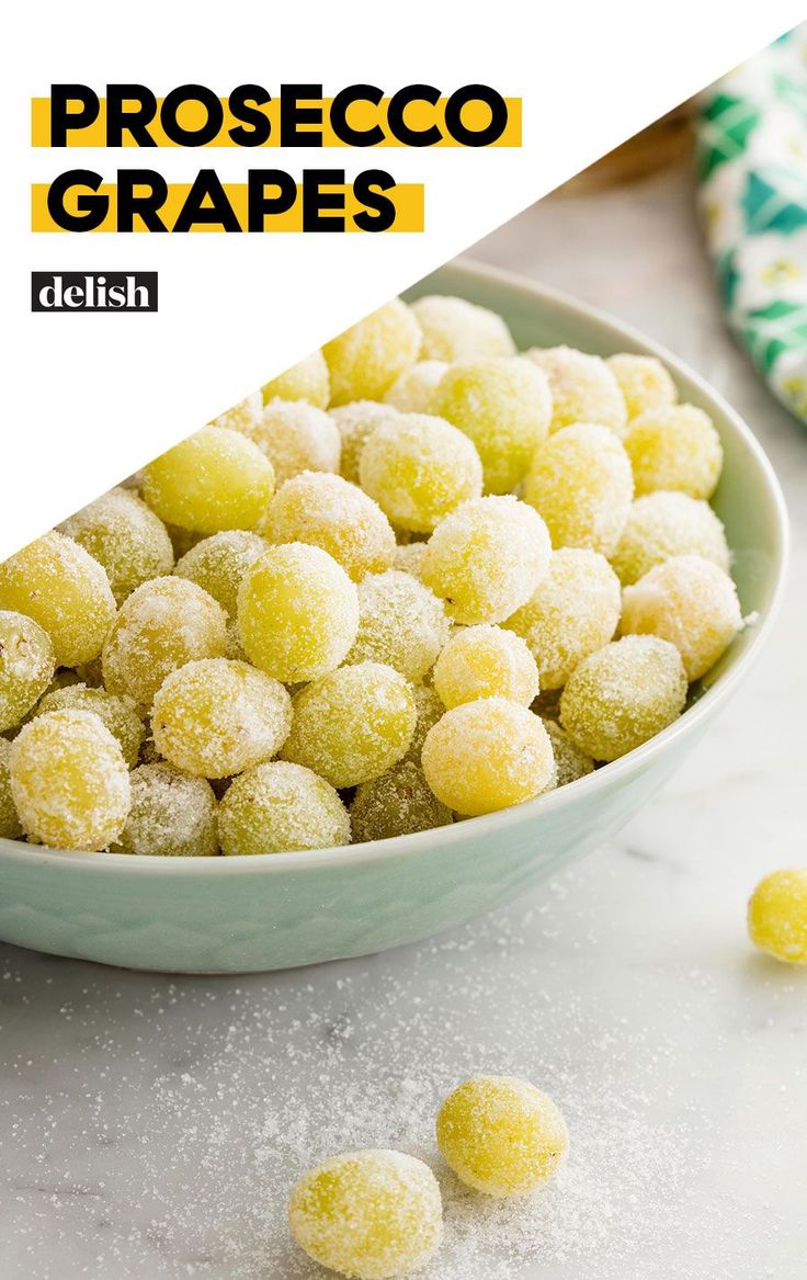 a white bowl filled with powdered sugar covered grapes