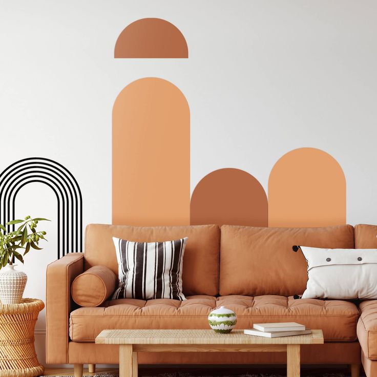 a living room with an orange couch and black and white wall