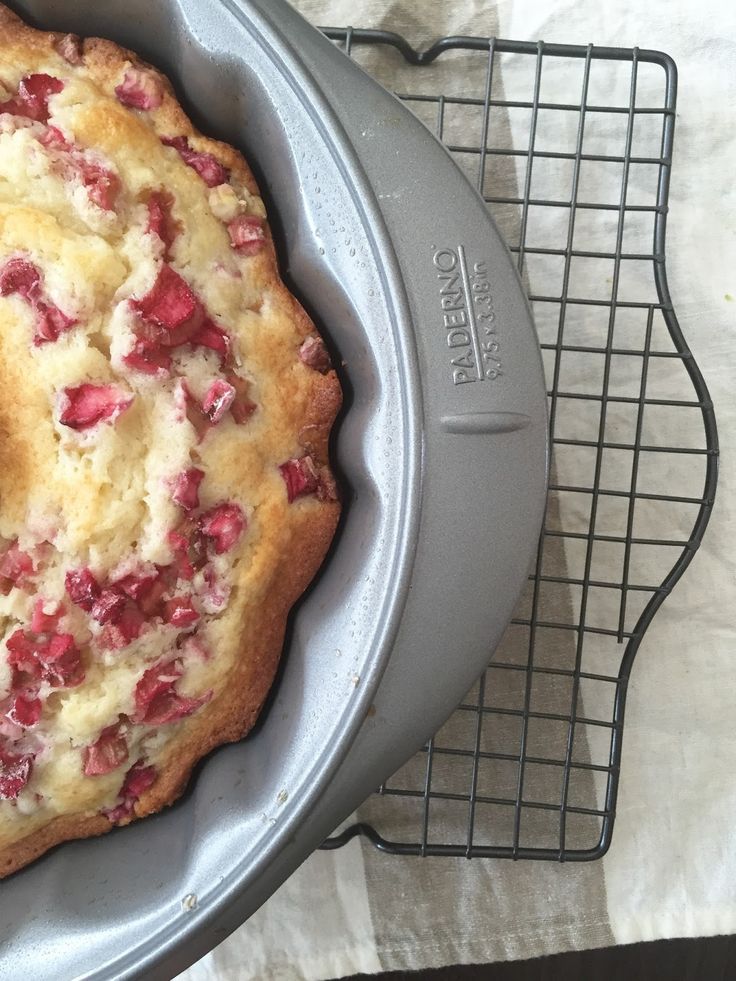 a cake that is sitting in a pan on a cooling rack next to a wire rack