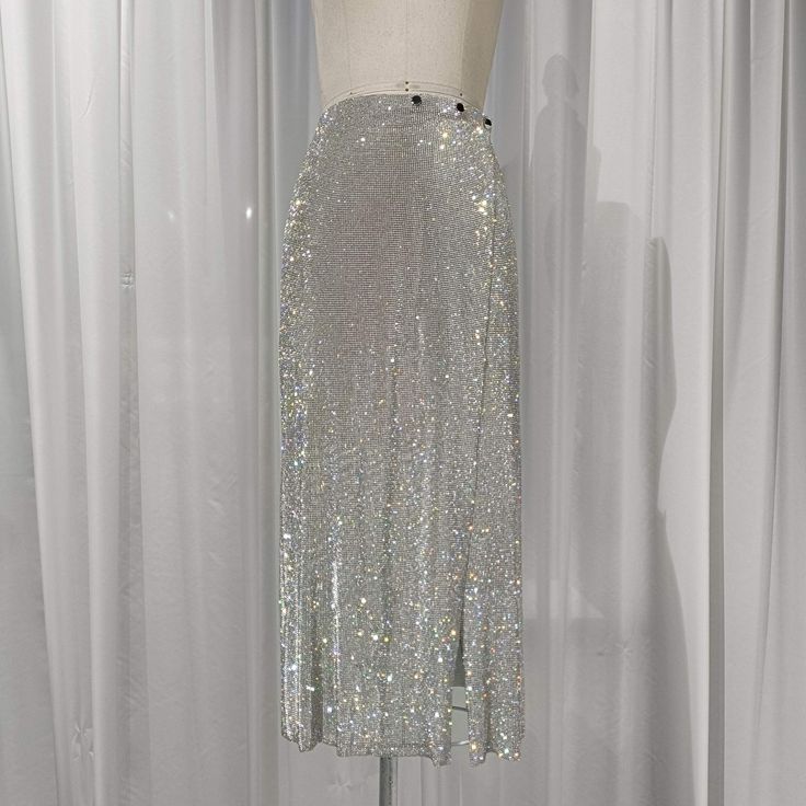 Step into elegance with this exquisite handmade Crystal Mesh Long Skirt, designed to make you shine with sophistication and grace. Perfect for evening events, special occasions, or any time you want to dazzle, this rhinestone maxi skirt is a true showstopper. Made from premium crystal mesh fabric, the skirt shimmers and sparkles with every movement, creating a captivating effect under the light. The skirt features a flattering A-line silhouette that drapes beautifully, providing a flowing and fe Rhinestone Fabric, Mesh Fashion, Party Rock, Crystal Fashion, Silver Fabric, Simple Blouse, Party Skirt, Midi Length Skirts, Mesh Skirt