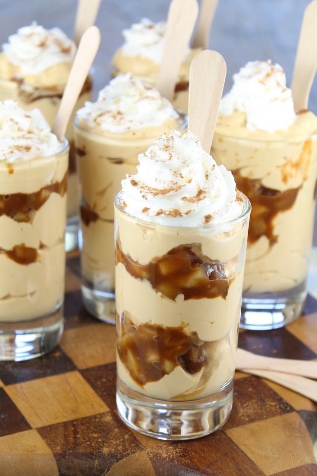 four desserts with marshmallow topping on a checkered table