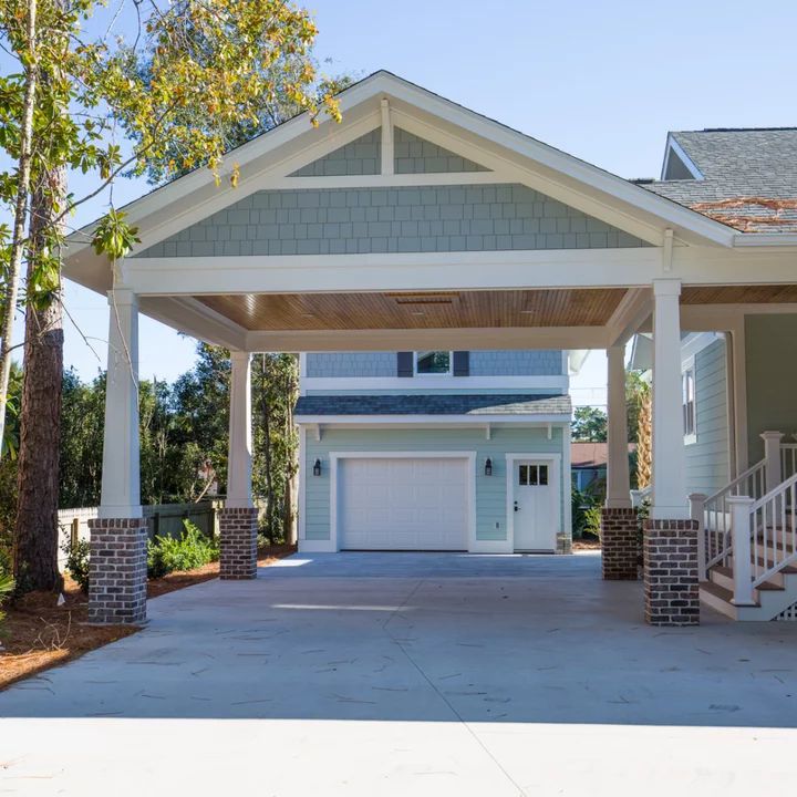 the front entrance to a home with two car garages