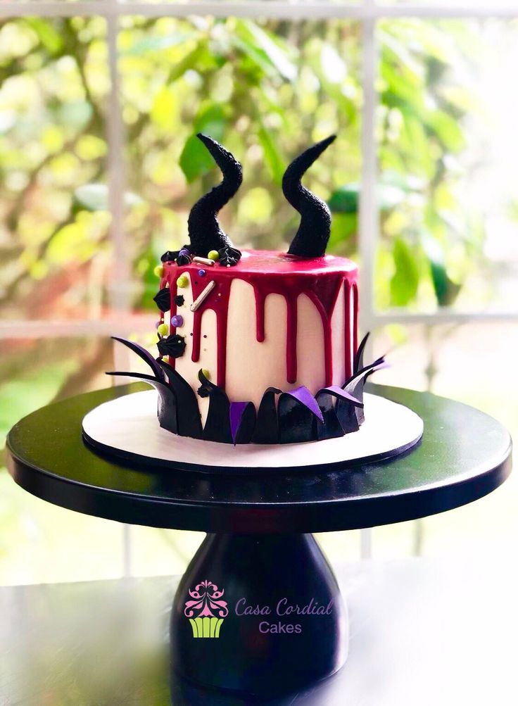 a red and white cake sitting on top of a table