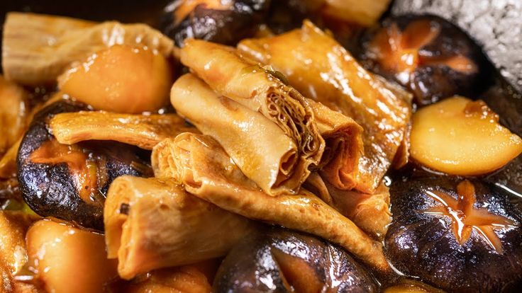 a close up view of some food in a bowl with broth and other things