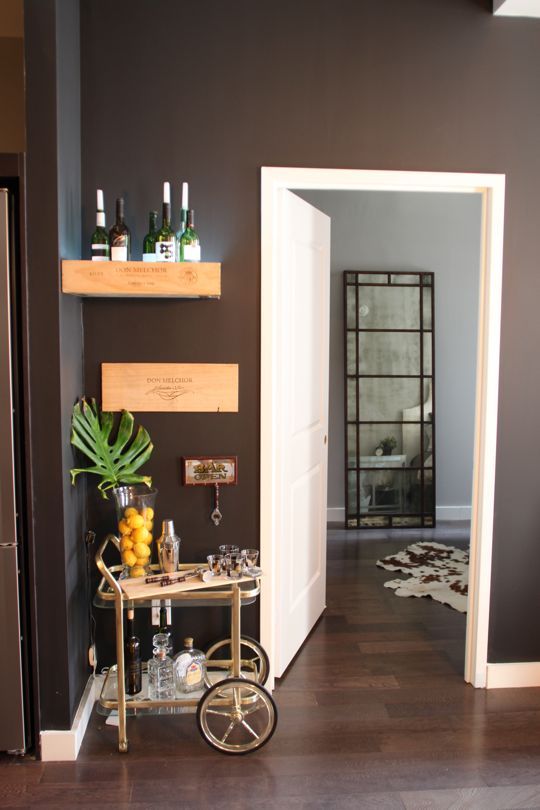 an entry way with a bar cart in the middle