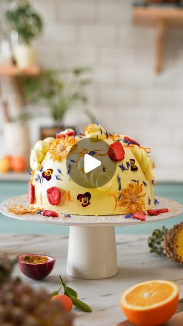 a cake with fruit on it sitting on top of a table