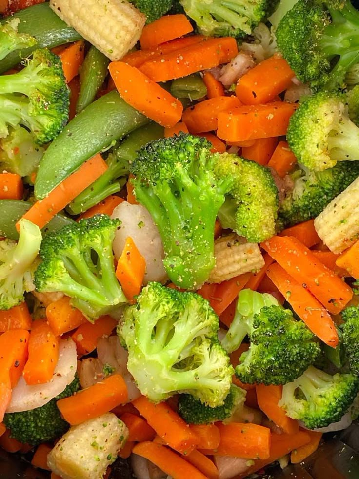 broccoli, carrots and onions are mixed together