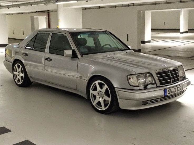 a silver car is parked in a parking garage with no one on the ground or people around it