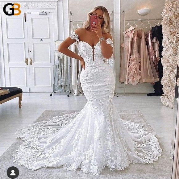 a woman taking a selfie in her wedding dress while looking at herself in the mirror