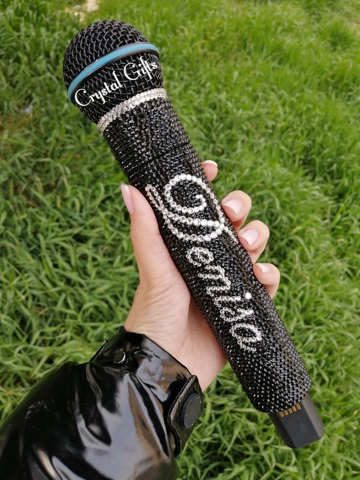 a person holding a black microphone in their hand with the words capital gift written on it