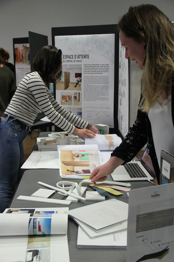 two women looking at papers on a table