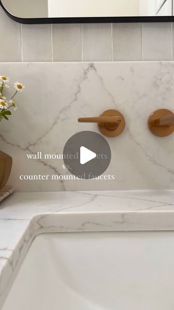 a bathroom sink with marble counter top and wooden faucets on the wall next to it