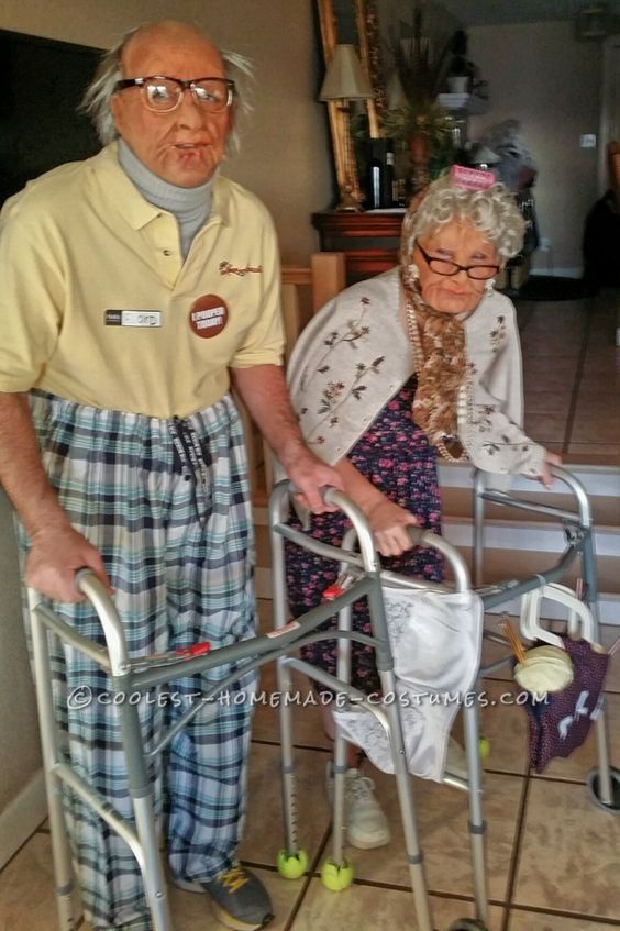 an elderly man and woman standing next to each other with walker wheels on the floor