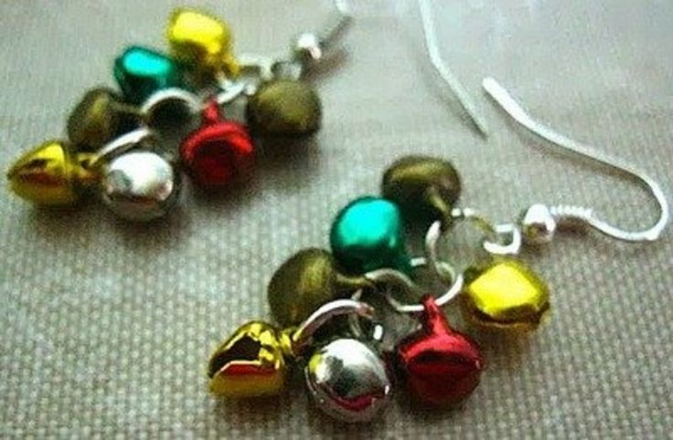 two pairs of earrings with bells hanging from it's earwires on a table