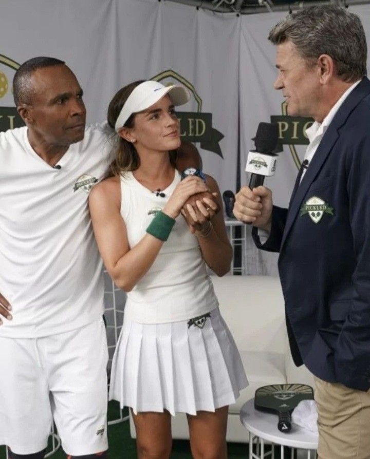 two tennis players are talking to an announcer