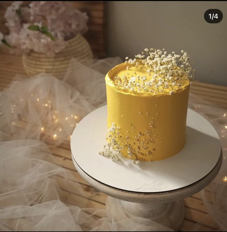 there is a yellow cake with white sprinkles on the top of it