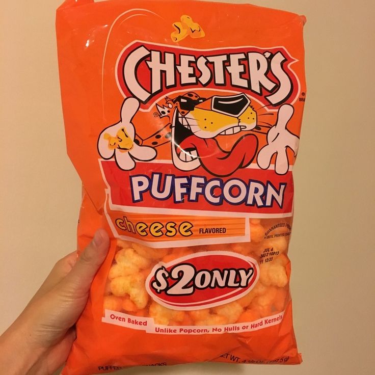 a hand holding a bag of cheetos popcorn