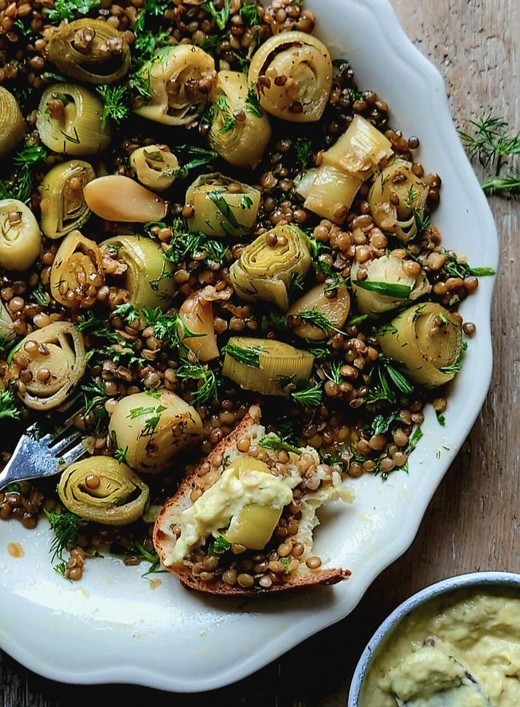 a white plate topped with vegetables and lentils