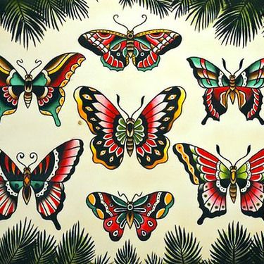 a group of colorful butterflies sitting on top of a white wall next to palm trees