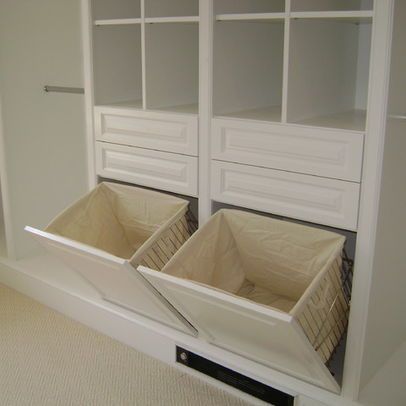 two bins in the middle of a closet with white walls and carpeted floor