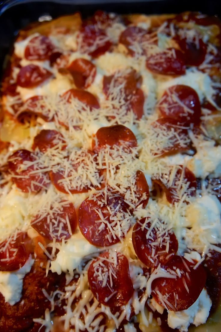 a pizza covered in cheese and pepperoni