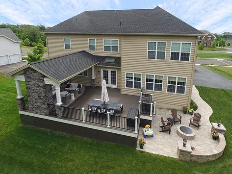 this is an aerial view of a house with patio and outdoor living area in the background