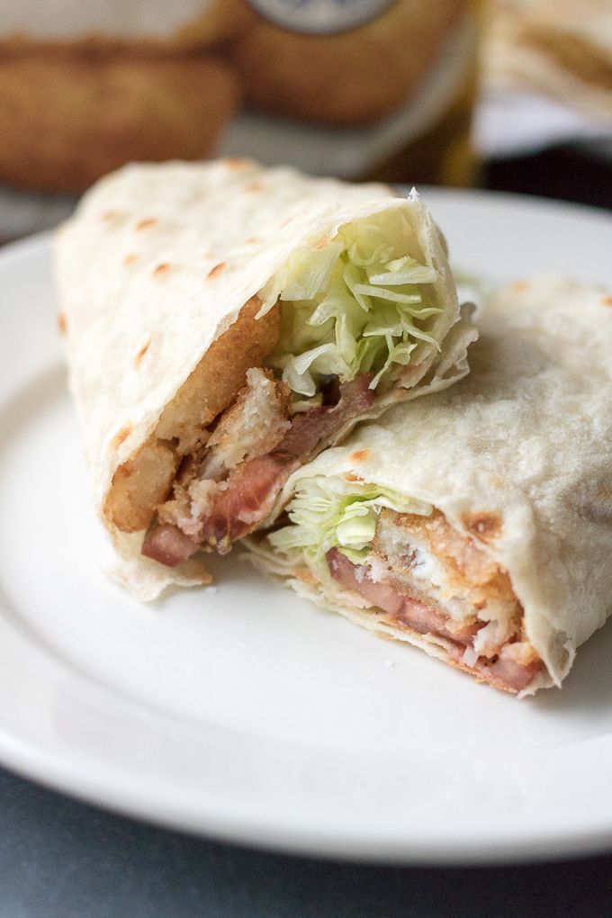 a close up of a burrito on a plate