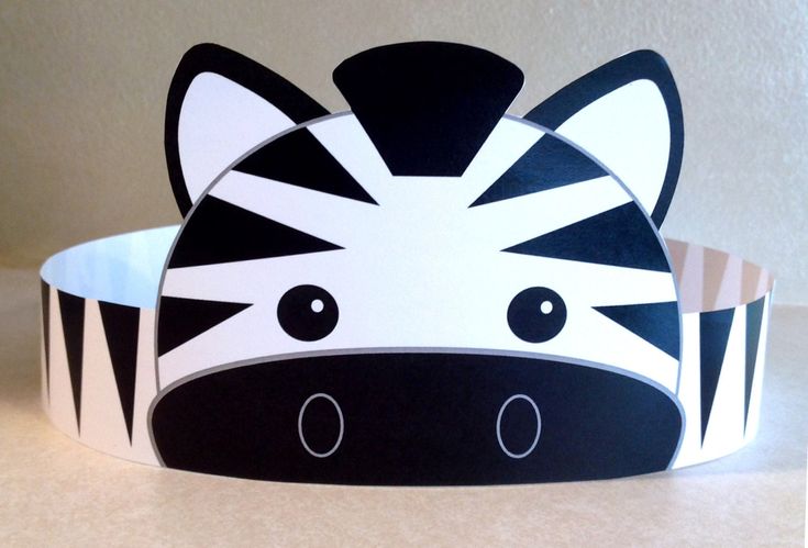 a zebra headband is shown on a white surface with black and white stripes in the background