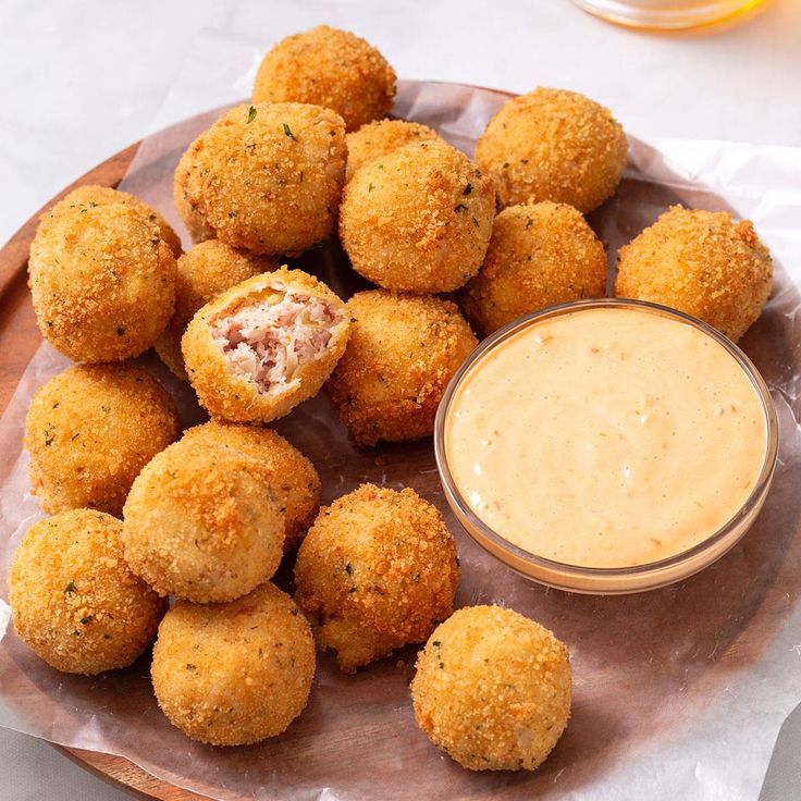 some food on a plate with dipping sauce