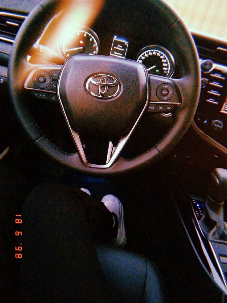 the interior of a car with steering wheel and dashboard