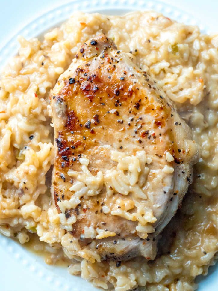 chicken and rice is served on a white plate