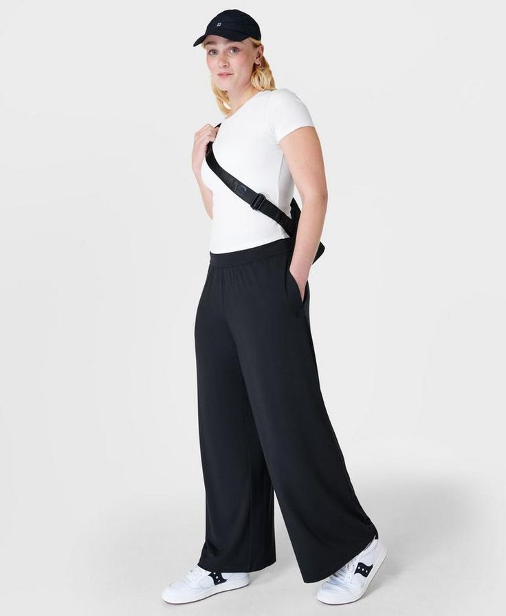 Our super comfortable trousers for luxe lounging. Soft, sustainable fabric made from plant-based modal Lenzing™ yarn. Effortless pull on design and a relaxed wide leg fit. Wear high rise or with the wide waistband folded down. 2 subtle slip pockets at the hips. Rise length for size S: 9" / 23cm. Inseam length: 29" / 73cm.. Model wears size S and is 178cm/5'10"tall. Style Code: SB8238Colour: Black Versatile Relaxed Fit Yoga Pants For Lounging, Chic Wide-leg Yoga Pants, Versatile Full-length Yoga Pants For Lounging, Casual Wide Leg Activewear For Relaxation, Comfort Stretch Wide Leg Lounge Pants, Wide Leg Comfort Stretch Pants For Lounging, Comfort Stretch Wide Leg Pants For Lounging, Wide Leg Relaxed Fit Activewear For Casual Use, Wide-leg 4-way Stretch Loungewear Pants