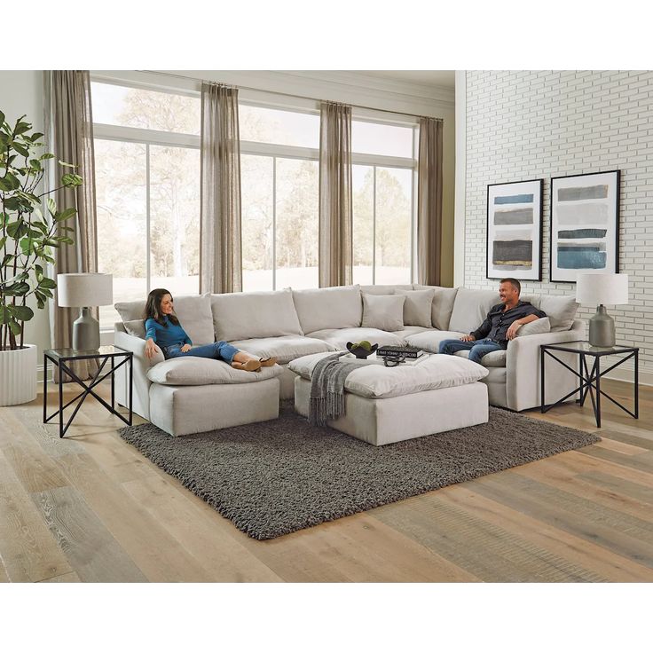 a man and woman sitting on a couch in a living room