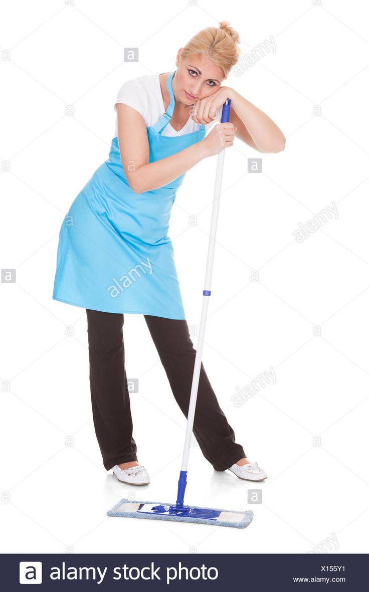 a woman in an apron cleaning the floor with a mop