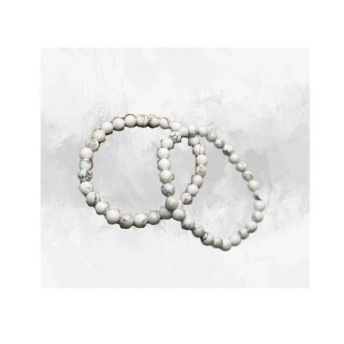 Immerse yourself in the innate calmness of our White Howlite Bracelet. Each piece is handcrafted with love, using grade AAA 8mm Howlite beads, effortlessly strung on a durable stretch cord. This unique piece not only serves as a stylish accessory but also a tranquil companion, known for its soothing energies. The bracelet's clean and polished finish ensures a comfortable fit and a timeless look that effortlessly complements any outfit. Alongside its aesthetic allure, the bracelet brings the spiritual benefits of Howlite, a gemstone believed to promote relaxation and emotional well-being. Handmade White Crystal Spiritual Bracelet, Handmade White Spiritual Crystal Bracelet, White Beaded Bracelets With 108 Beads For Meditation, White Crystal Bracelet With 8mm Beads, Handmade White Crystal Round Bracelet, Handmade White Crystal Bracelet, White Howlite Bracelets With Natural Stones, White Crystal Bracelet With 8mm Round Beads, Spiritual White Jewelry For Meditation