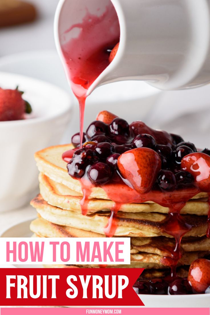 a stack of pancakes with syrup being drizzled over them and topped with strawberries