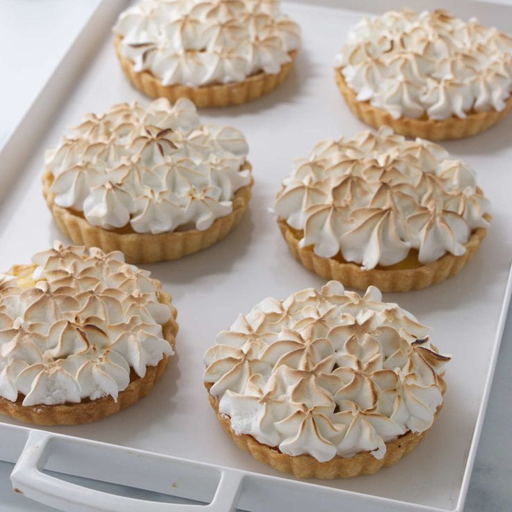 there are many desserts on the tray ready to be eaten