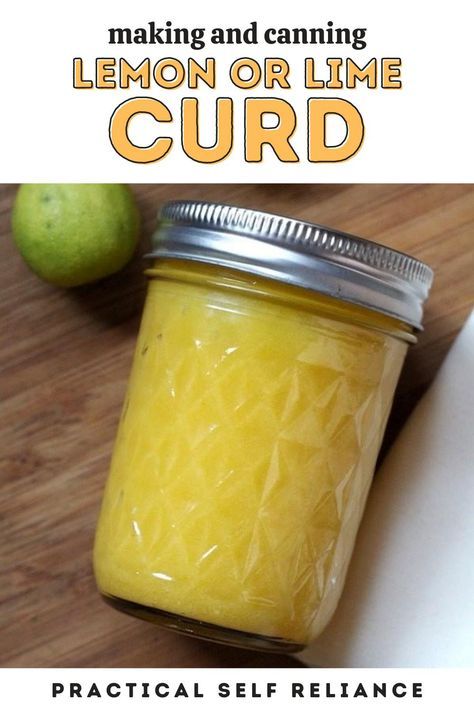 a jar filled with lemon or lime curd sitting on top of a wooden table