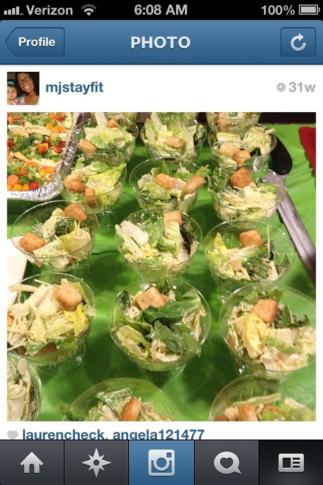 a table full of salads and other food items on top of green trays